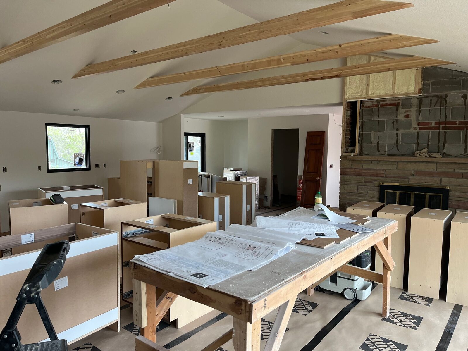 Exposed roof trusses and framing during construction of a Forge & Bow new build