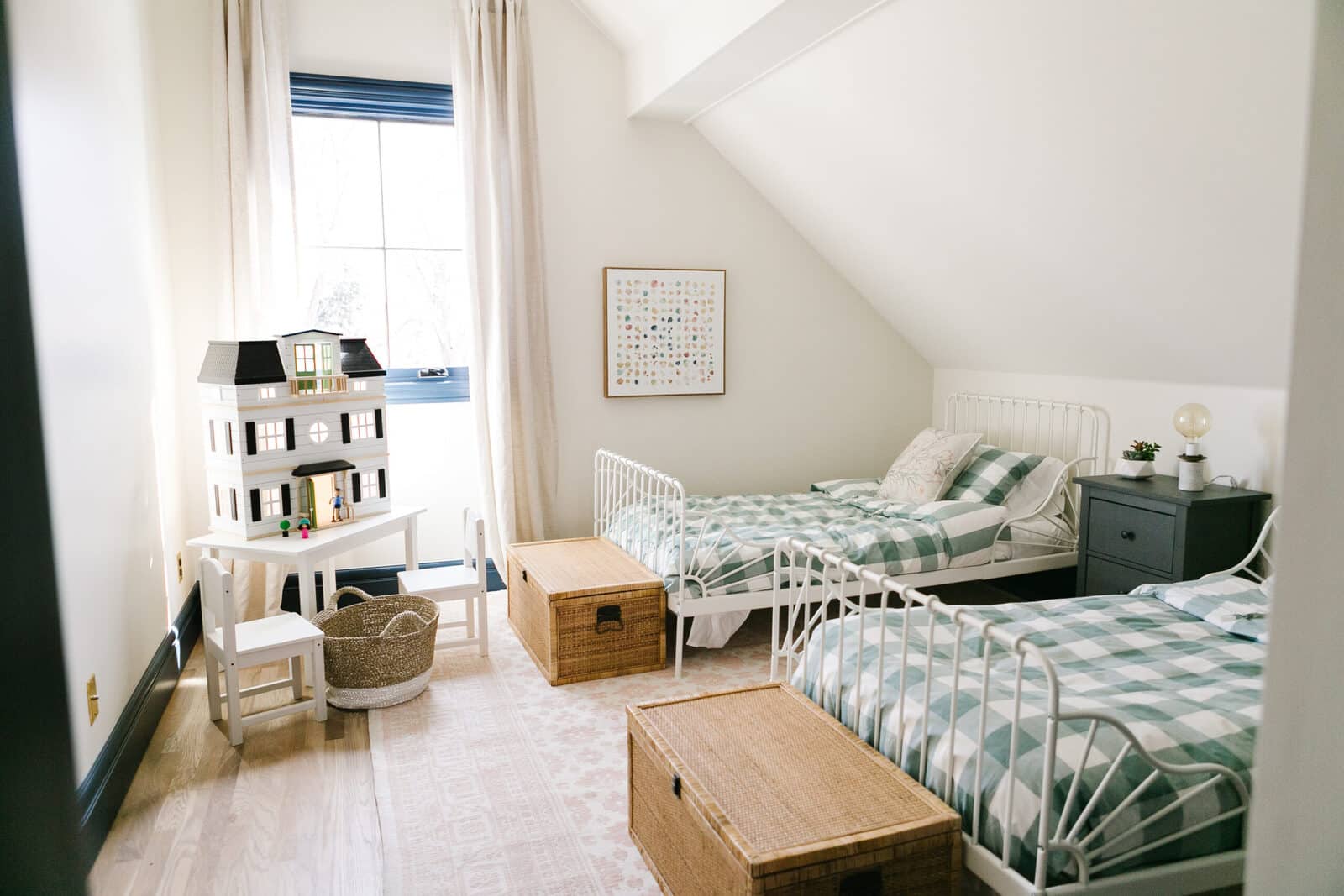 Twin bedroom with white iron beds and gingham bedding in the Whedbee Residence renovation by Forge & Bow