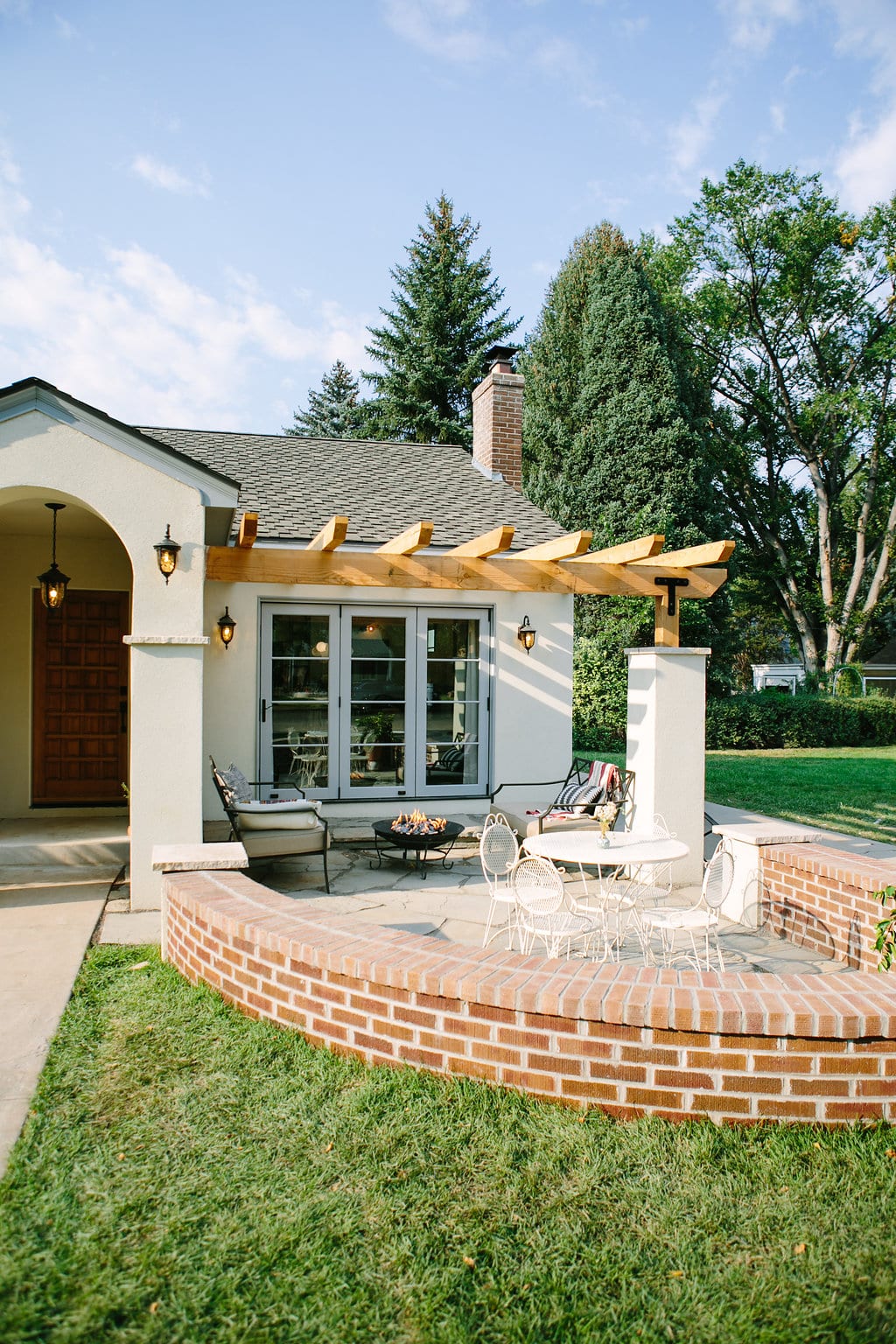 Backyard brick patio with a wood pergola in The Buckeye Dwelling renovation by Forge & Bow